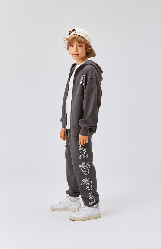 Pantalone in tuta grigia con simboli sui fianchi