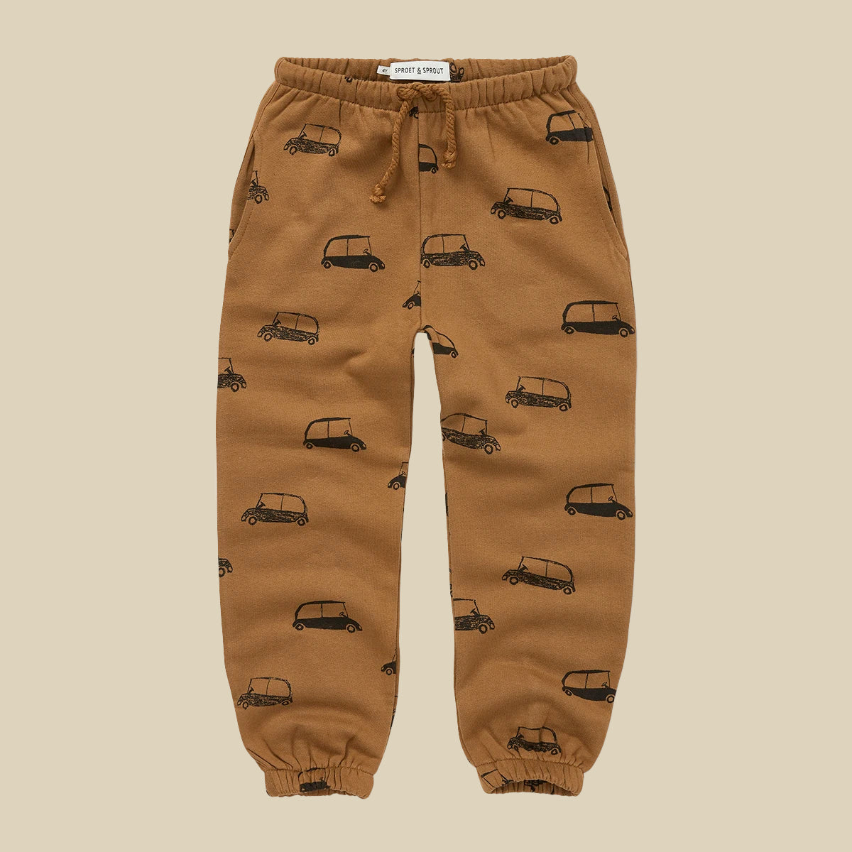 Pantaloni in tuta color biscotto con stampa macchinine