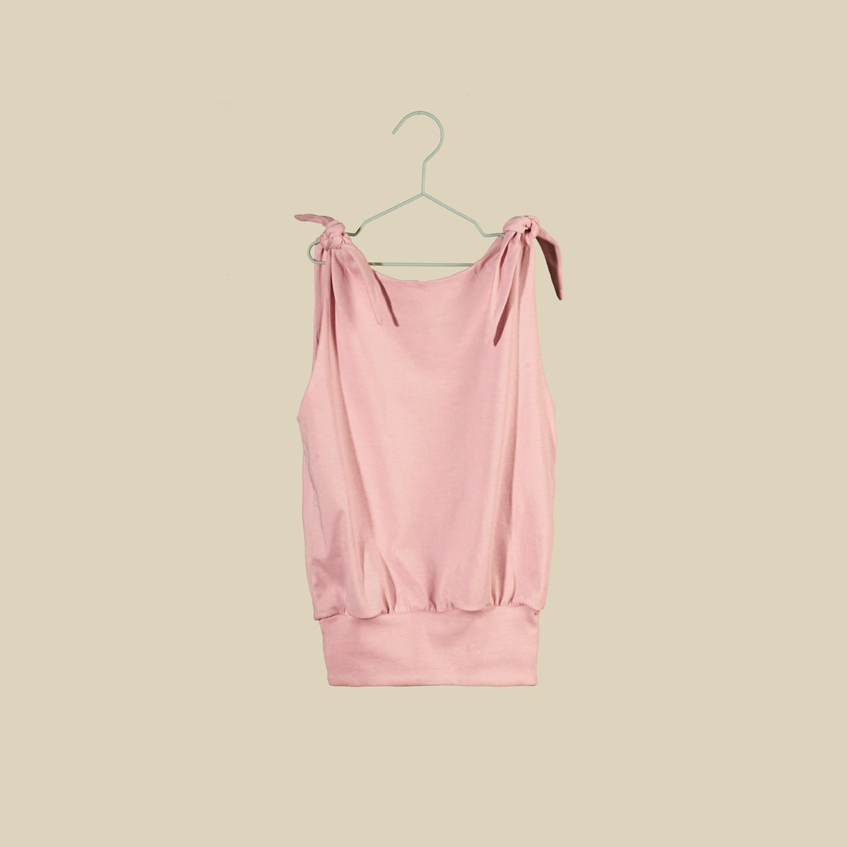 Top o mini abito rosa chiaro senza maniche con nodi